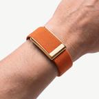 GripLoop Band Orange Gold — worn on wrist